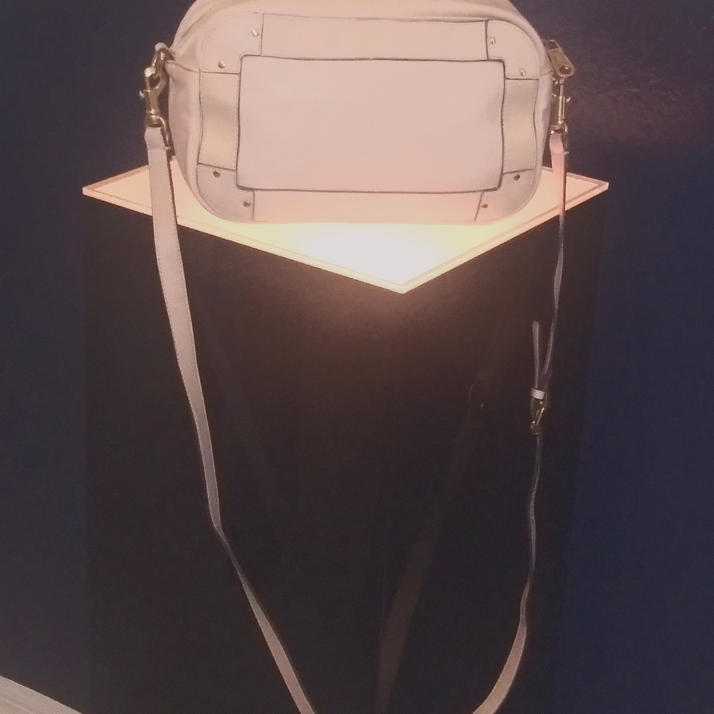 The Eden crossbody bag features a leather body wit